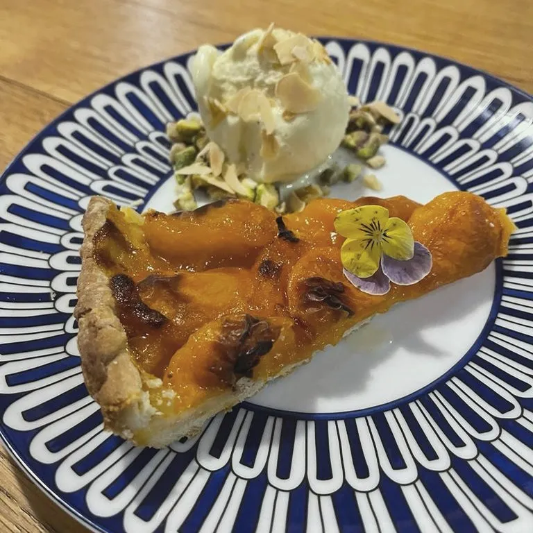 Apricot tart with ice cream and pistachios