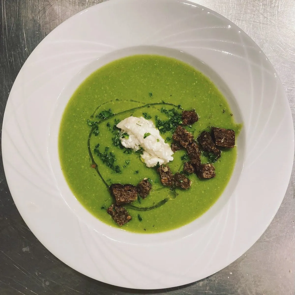 Green pea soup with fresh cheese and croutons